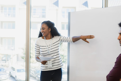 Image of a teacher standing at a whiteboard