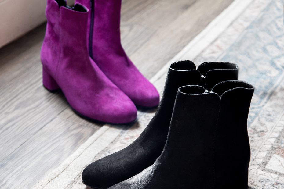 Gabor Abbey boots in black and orchid suede styled on a patterned rug.,