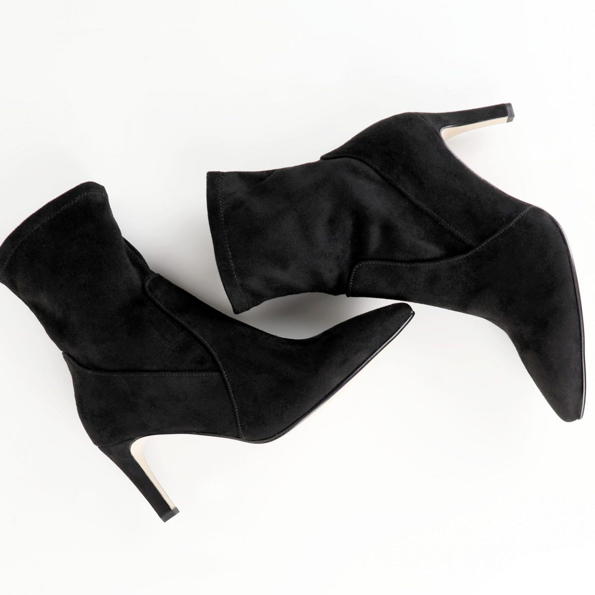 A pair of black shoes are set against a white background. The shoes, Bangle, have a small heel.