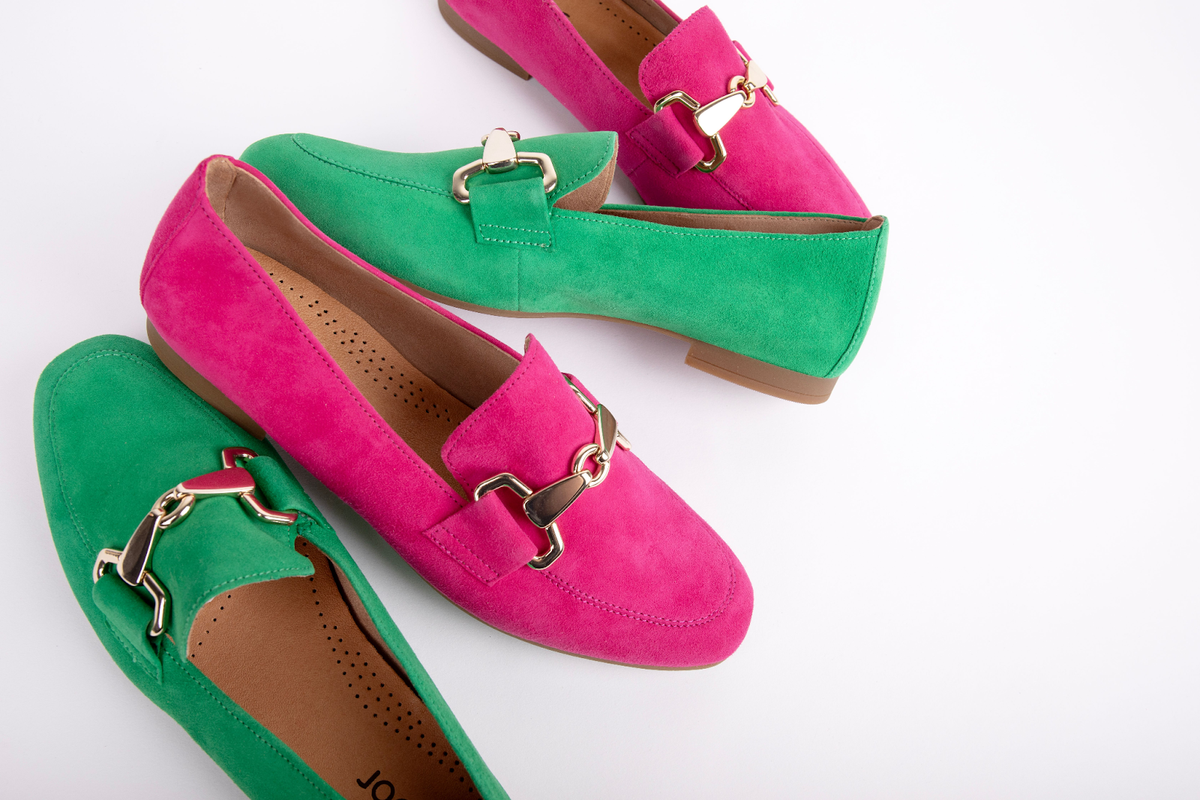 A pair of green shoes and a pair of pink shoes